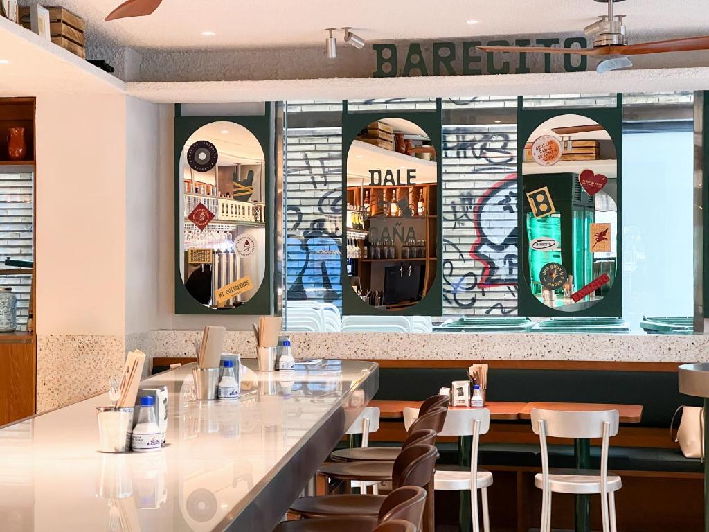 a restaurant with a bar with graffiti on the wall at Melia Plaza Valencia in Valencia