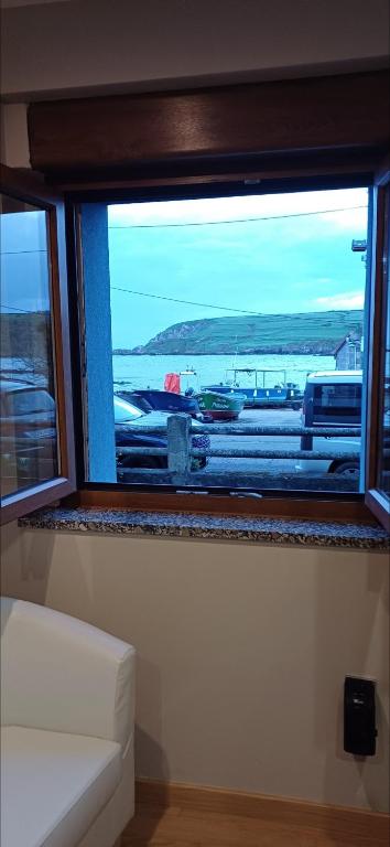 a window in a room with a view of a harbor at Vista marina VUT-7215-AS in Bañugues