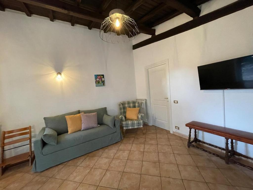 a living room with a couch and a flat screen tv at Il Cottage - Tenuta dell'Inviolata in Velletri