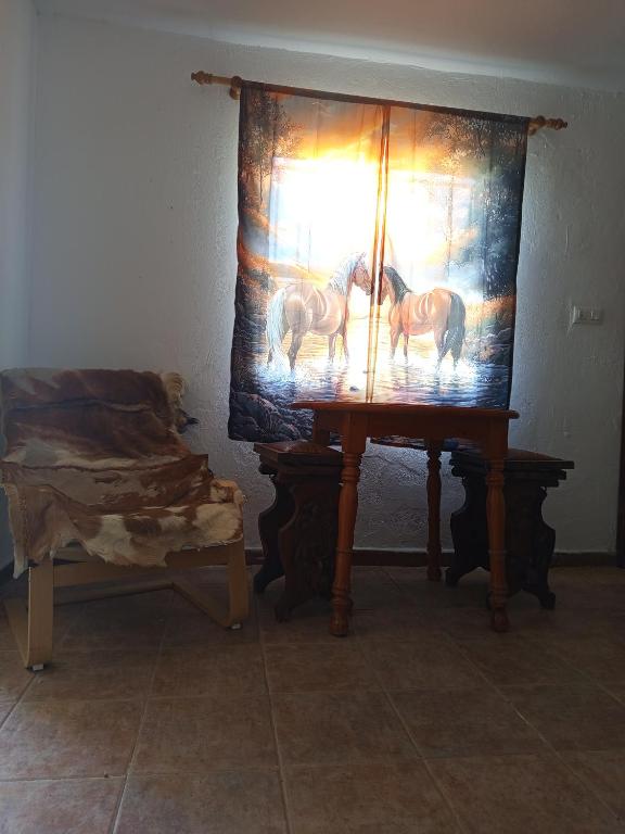 a table with a picture of horses on a curtain at El Girasol yellowstone in Chiclana de la Frontera
