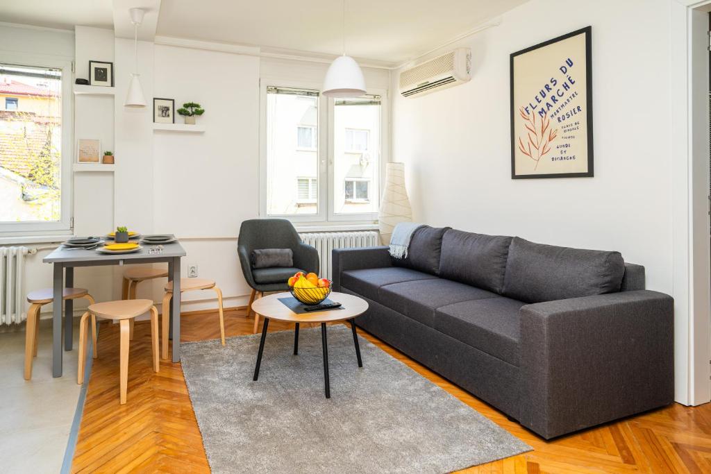 a living room with a couch and a table at Modern 1 BDR with Balcony in Sarajevo