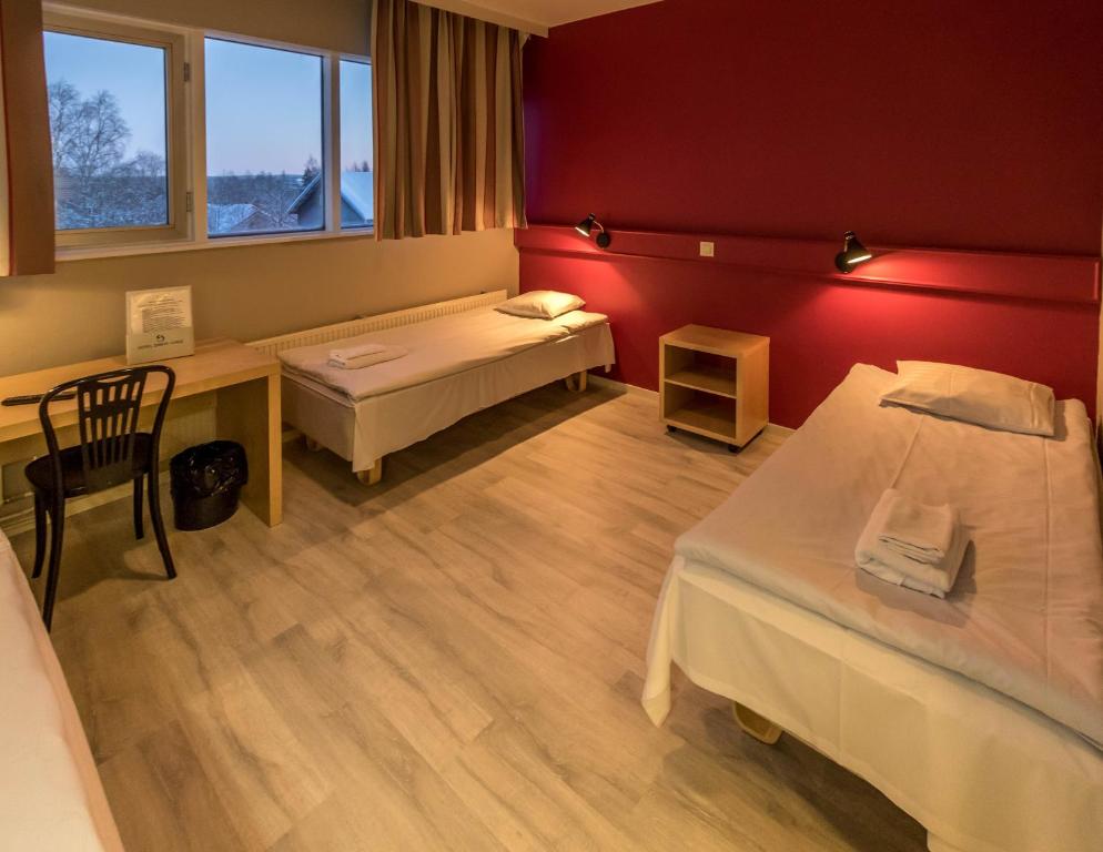 Vuode tai vuoteita majoituspaikassa Santa's Hotel Rudolf