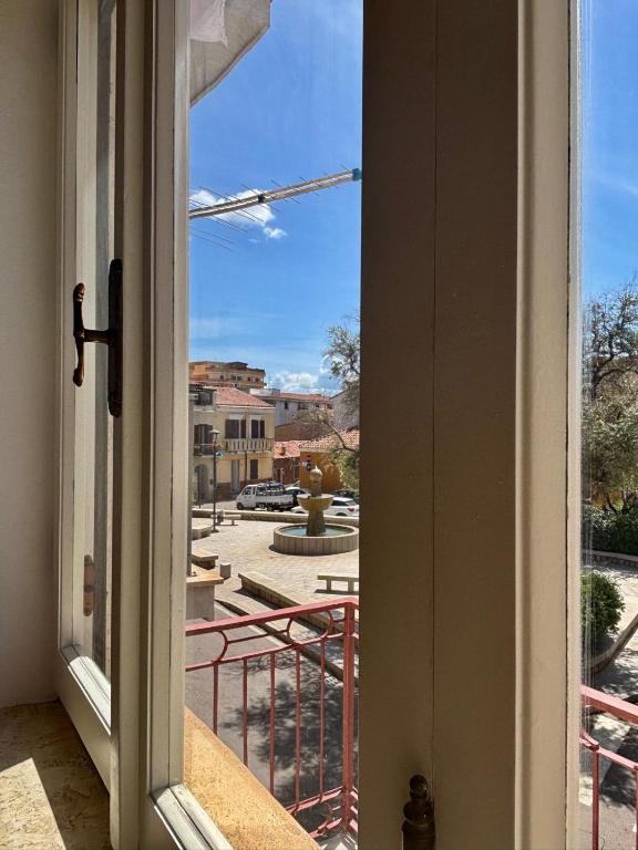 an open door to a balcony with a view at Casa sulla Piazzetta in Olbia