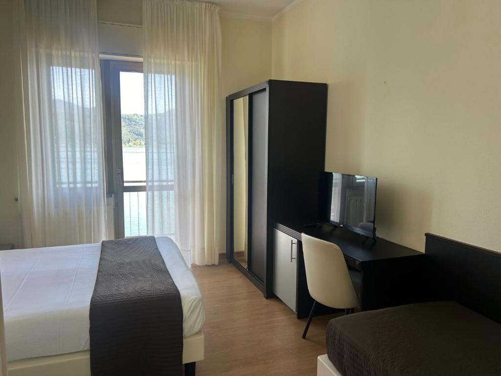 Postel nebo postele na pokoji v ubytování Hotel Carillon