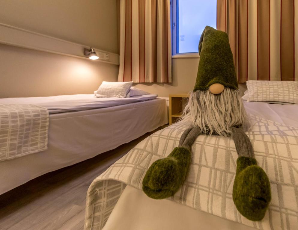Vuode tai vuoteita majoituspaikassa Santa's Hotel Rudolf
