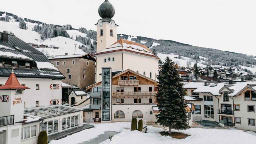 a town with a christmas tree in the snow at VAYA Post Saalbach Landhaus in Saalbach Hinterglemm
