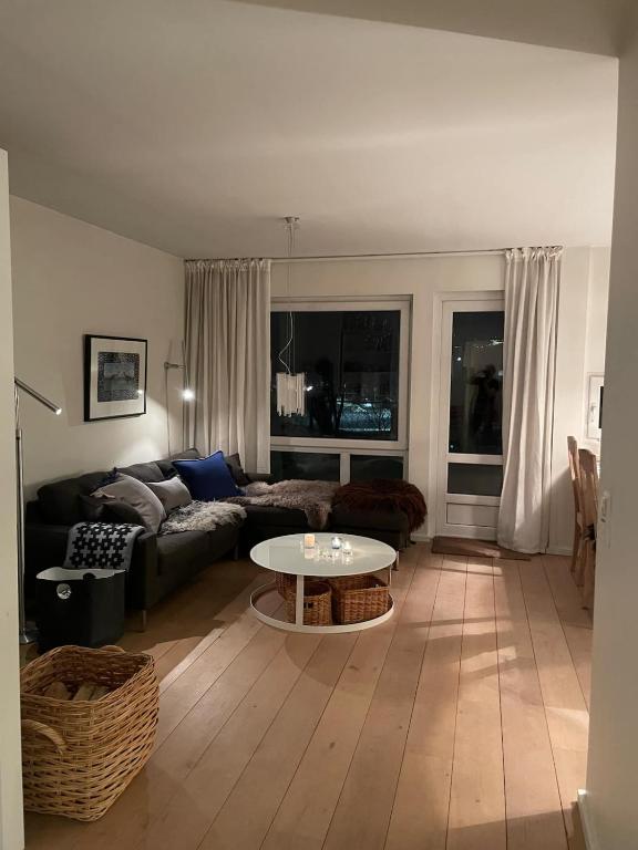 a living room with a couch and a table at Leisure apartment at Sinnes in Haugen