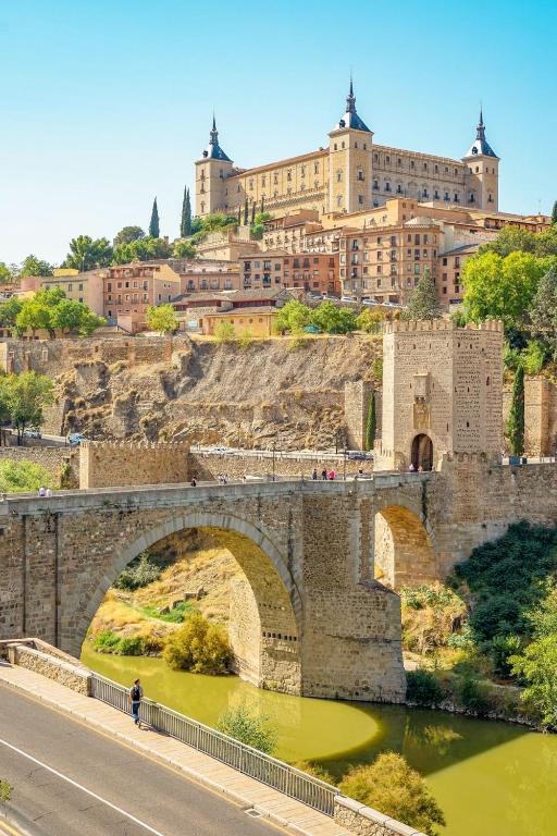 a bridge over a river in front of a city at Ave Maria Toledo in Toledo