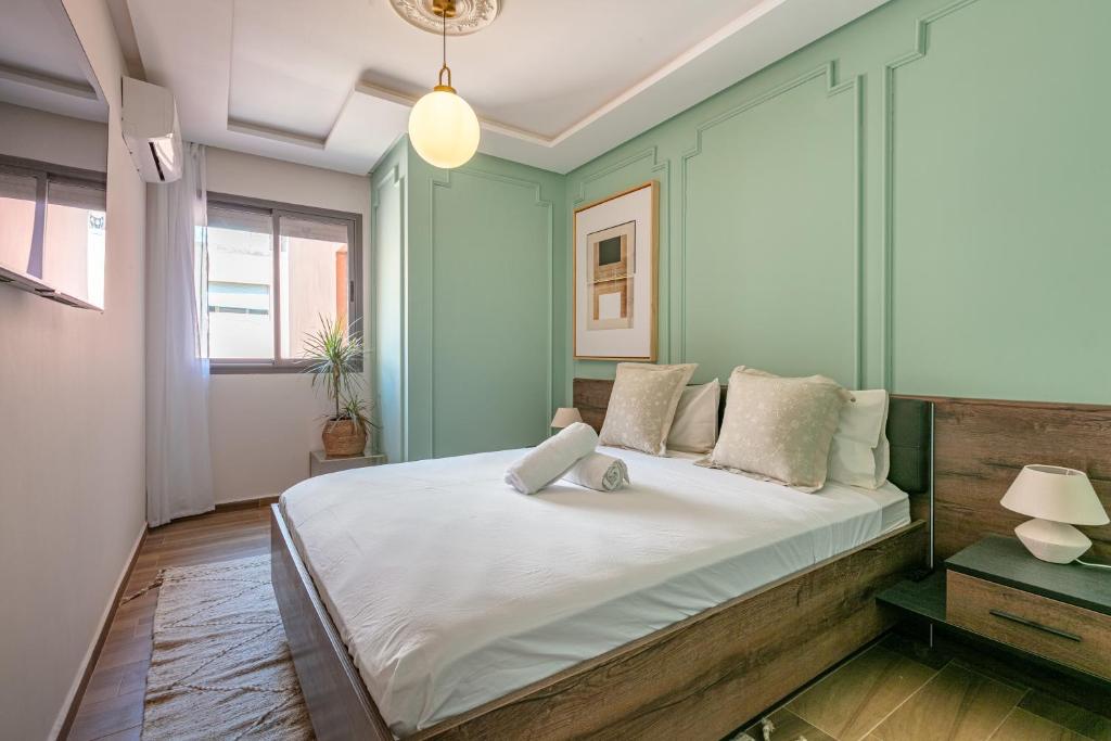 a bedroom with a large bed with white sheets at Migdal Jaouhara in Marrakech