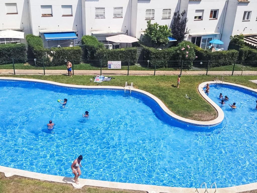 a group of people swimming in a swimming pool at Holiday Home Zona Estival-3 by Interhome in Salou