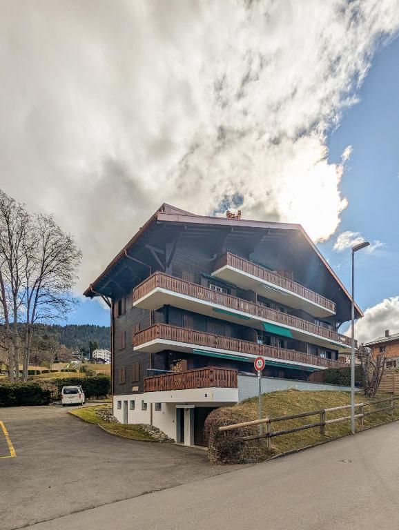 a large building with balconies on the side of a street at Rare, quite & centered Apartment with Garden & Fireplace in Villars-sur-Ollon