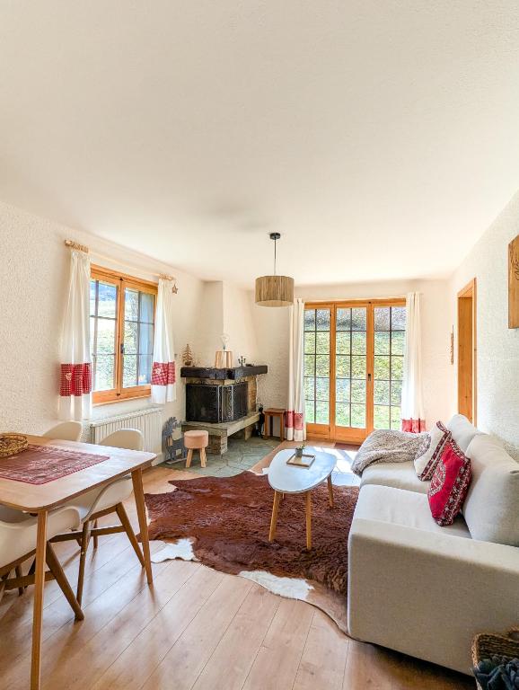 a living room with a couch and a table at Rare, quite & centered Apartment with Garden & Fireplace in Villars-sur-Ollon