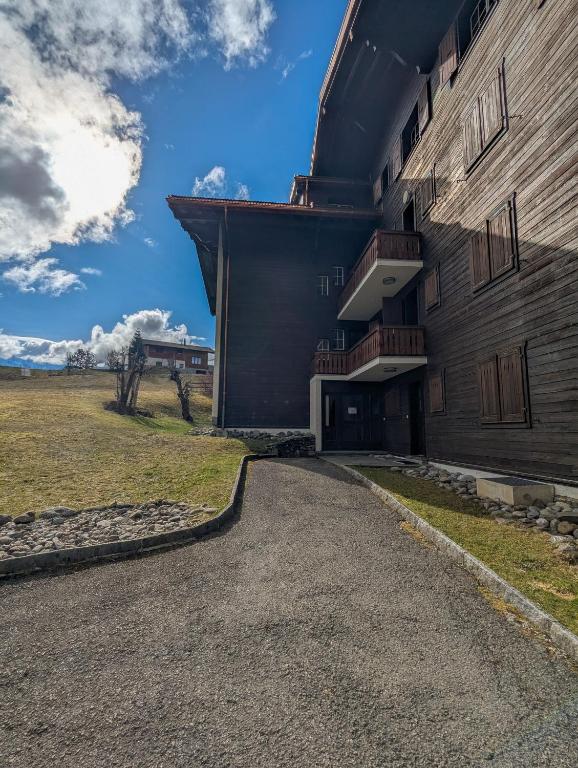 a building with a dirt road in front of it at Rare, quite & centered Apartment with Garden & Fireplace in Villars-sur-Ollon