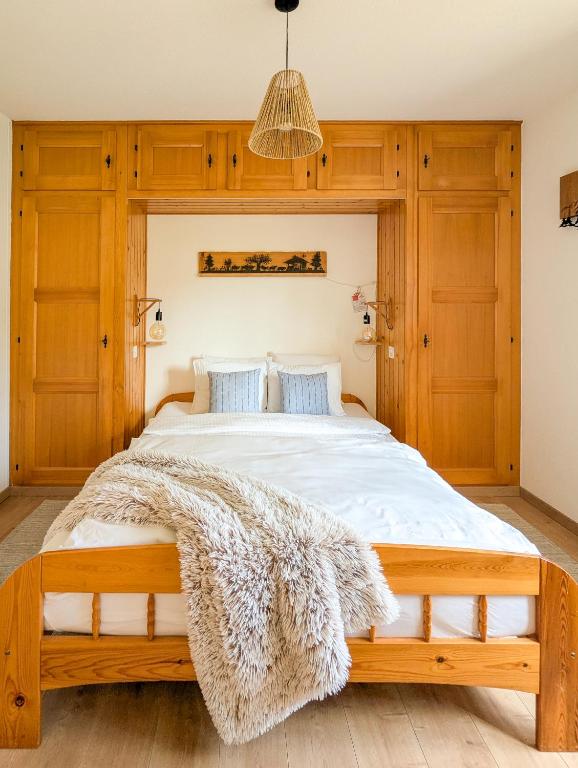 a bedroom with a large bed with a furry blanket at Rare, quite & centered Apartment with Garden & Fireplace in Villars-sur-Ollon