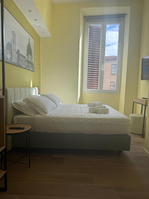 Postel nebo postele na pokoji v ubytování JR Hotels Hermes Firenze