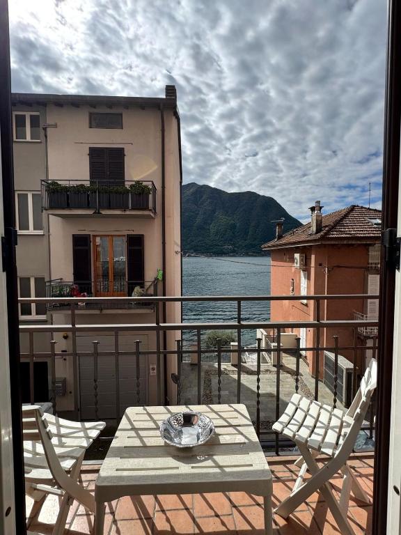 a patio with a table and chairs on a balcony at The Star - Apartment with Lake View in Colonno