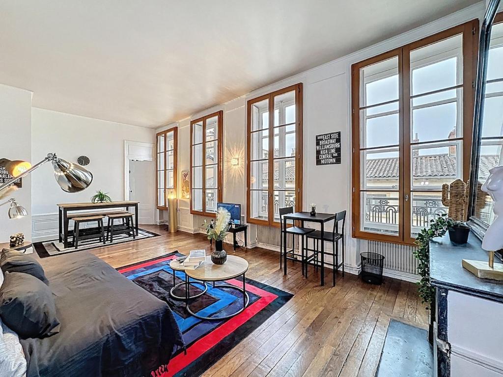 a living room with a bed and a table at Home Away tramassac 1 in Lyon