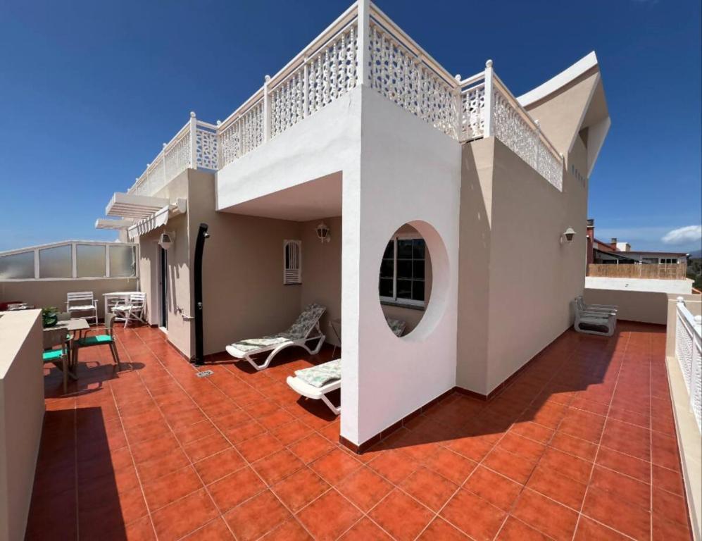 a balcony of a house with a white railing at Ático San Juan Teide View in Playa de San Juan