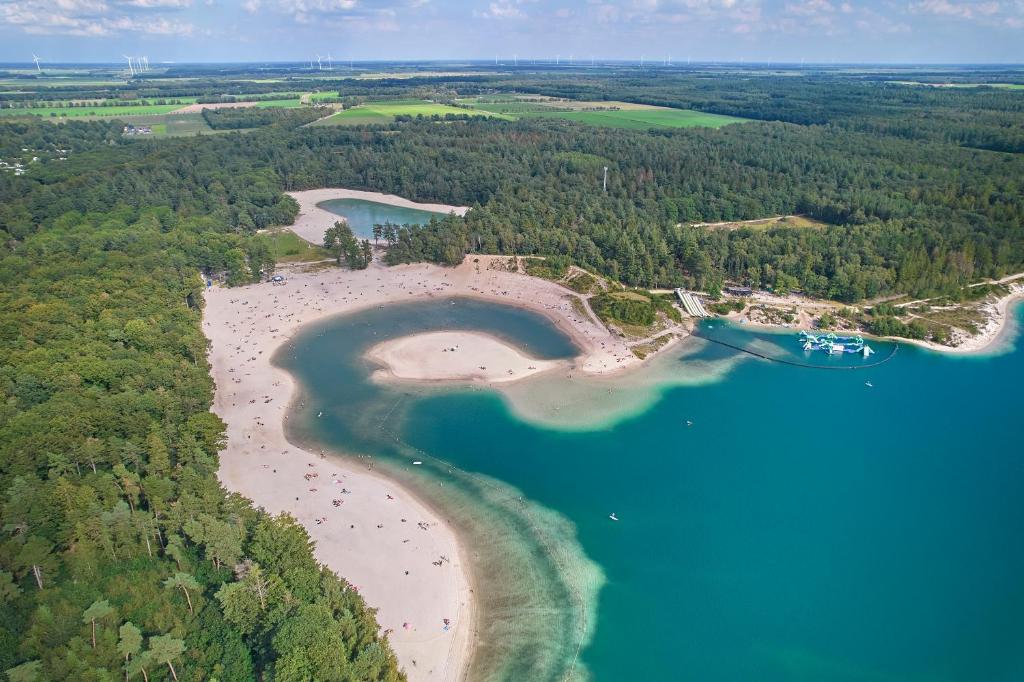 an aerial view of a beach with people on the sand and water at Siblu De Lente van Drenthe in Gasselte