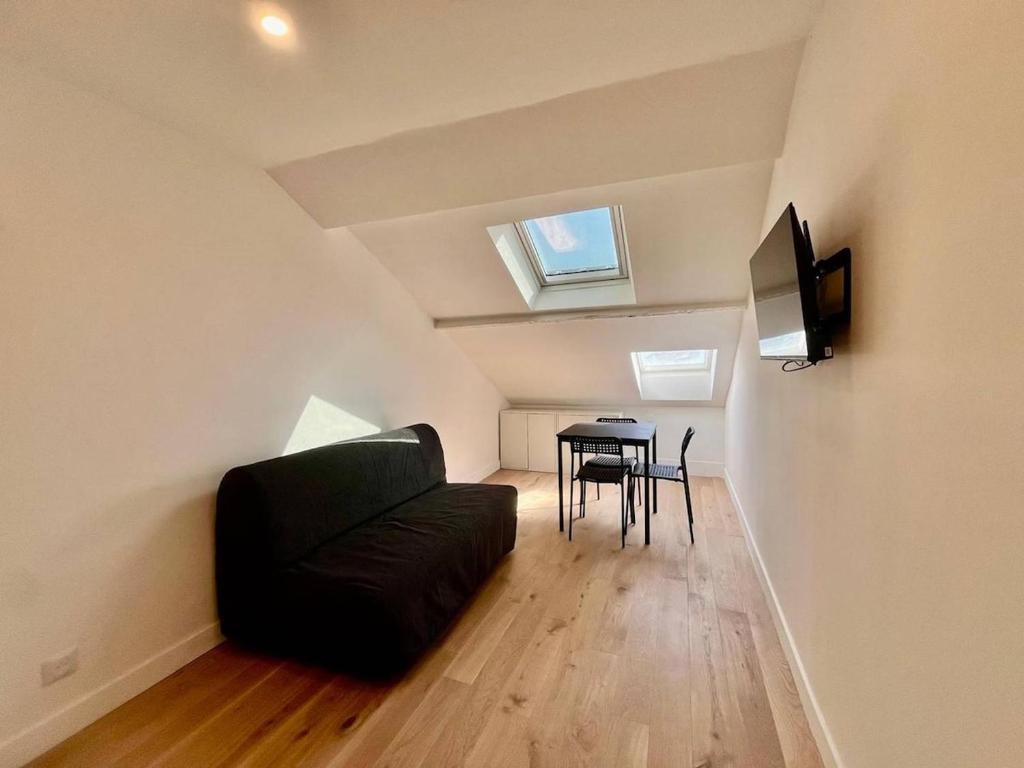 un salon avec un canapé noir et une table dans l'établissement Nice Signature Assalit 2P, à Nice