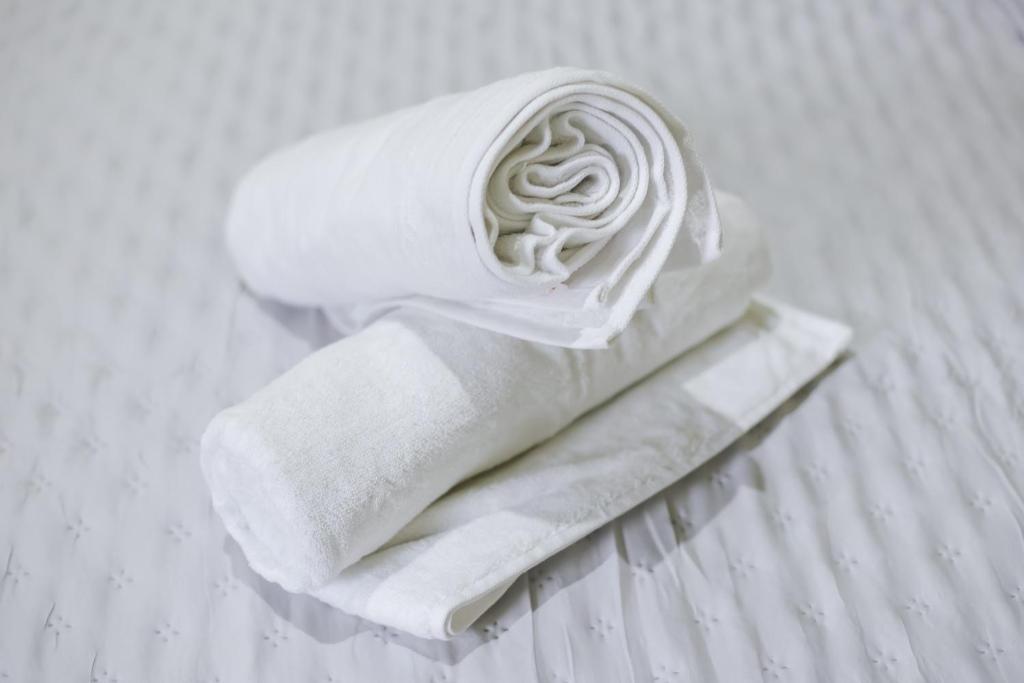 a stack of towels sitting on a bed at Senaru Gateway homestay in Senaru