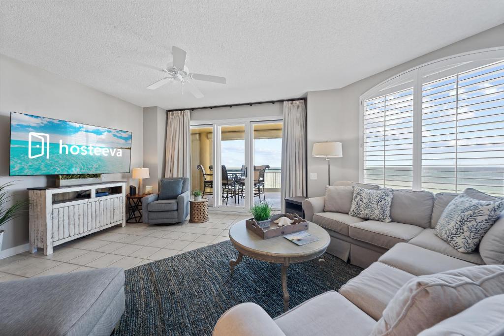 a living room with a couch and a tv at Beach Colony W7C - Covered Parking Included in Pensacola