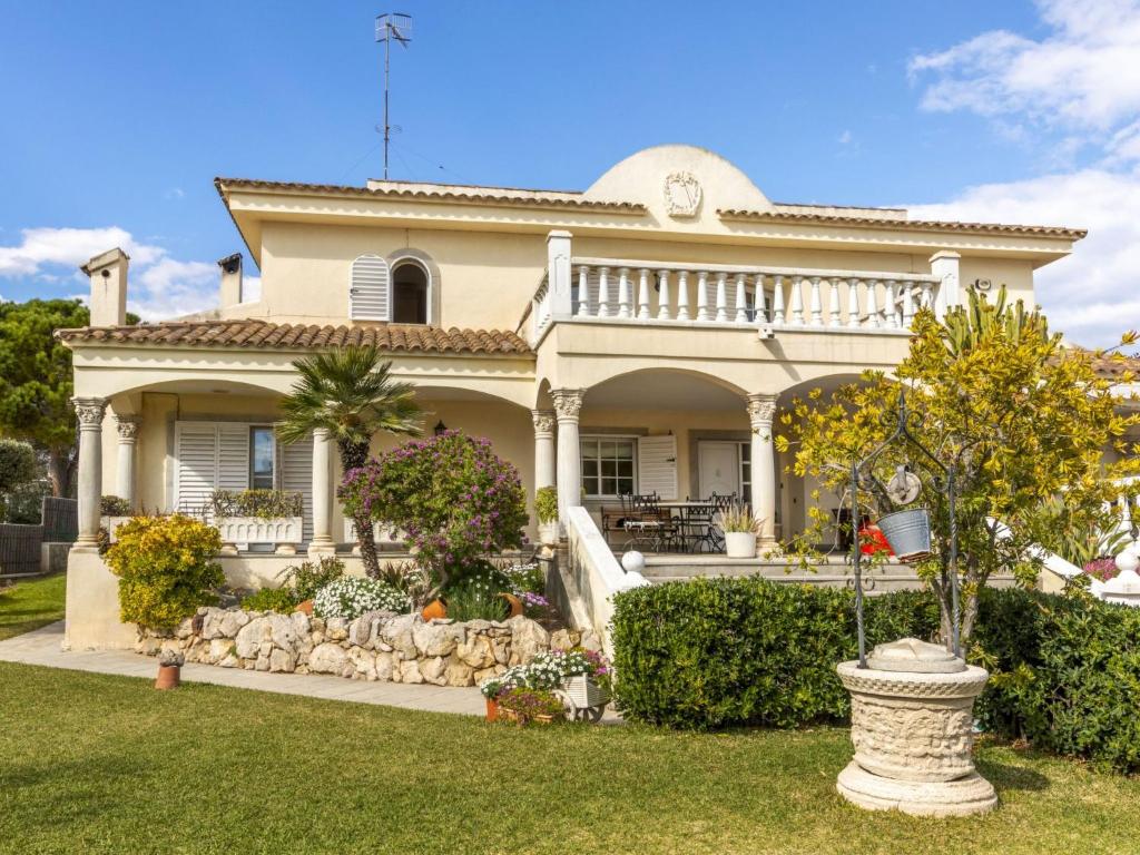 a large white house with a garden in front of it at Holiday Home Bon repos by Interhome in Cunit