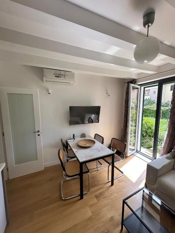 a living room with a table and a couch at Apartment DB in Split