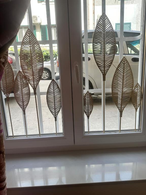 a window with a bunch of leaf decals on it at Apartment DB in Split