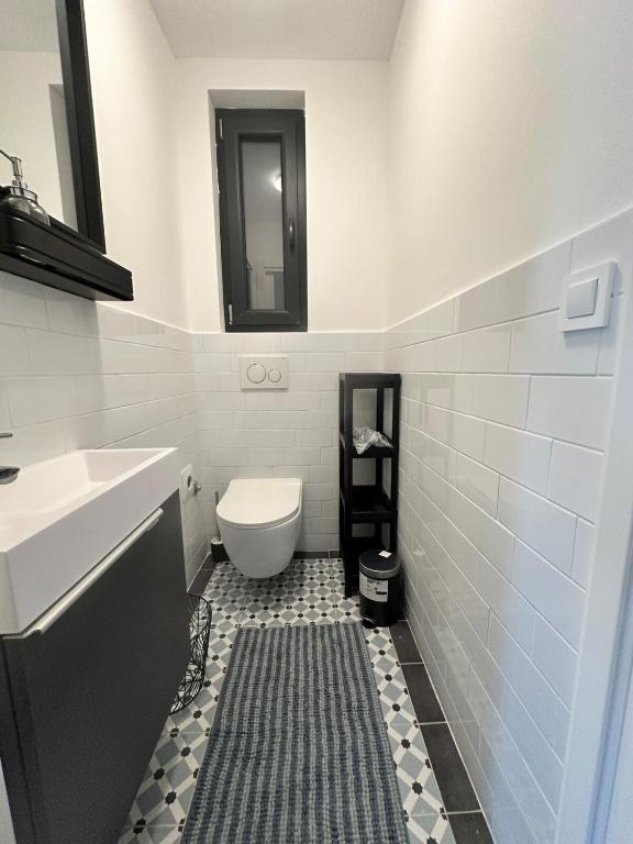 a bathroom with a toilet and a sink and a mirror at Apartment DB in Split
