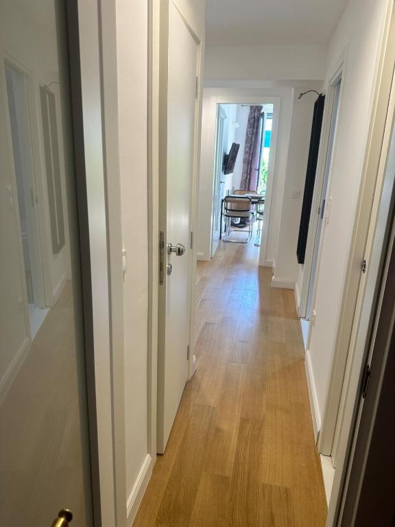 a hallway with white walls and a wooden floor at Apartment DB in Split