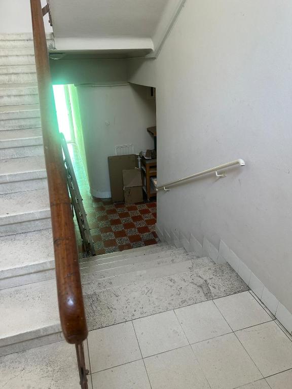 an empty hallway with stairs and a hand rail at Apartment DB in Split