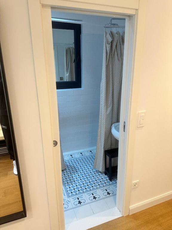 a bathroom with a walk in shower next to a mirror at Apartment DB in Split