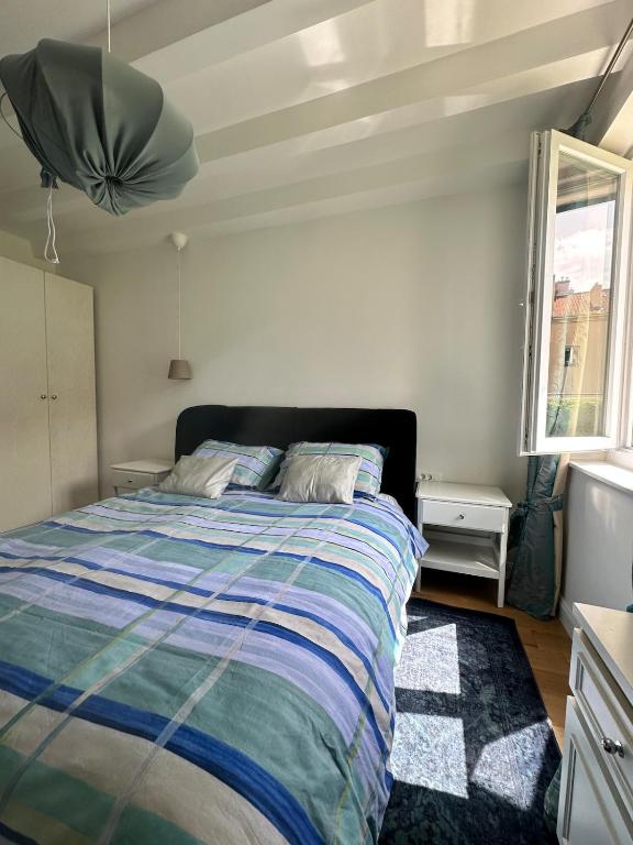 a bedroom with a bed with a striped comforter at Apartment DB in Split