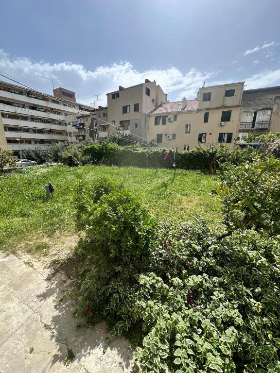 a field of grass with buildings in the background at Apartment DB in Split