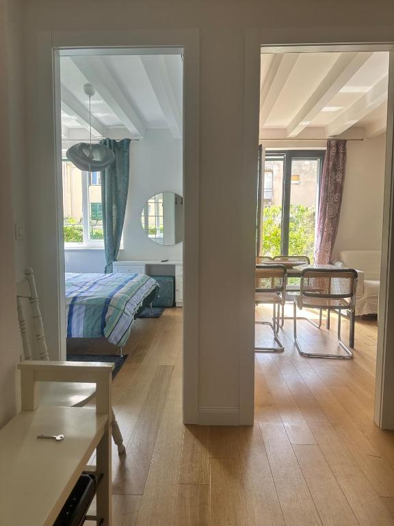 a bedroom and a living room with a bed and a table at Apartment DB in Split
