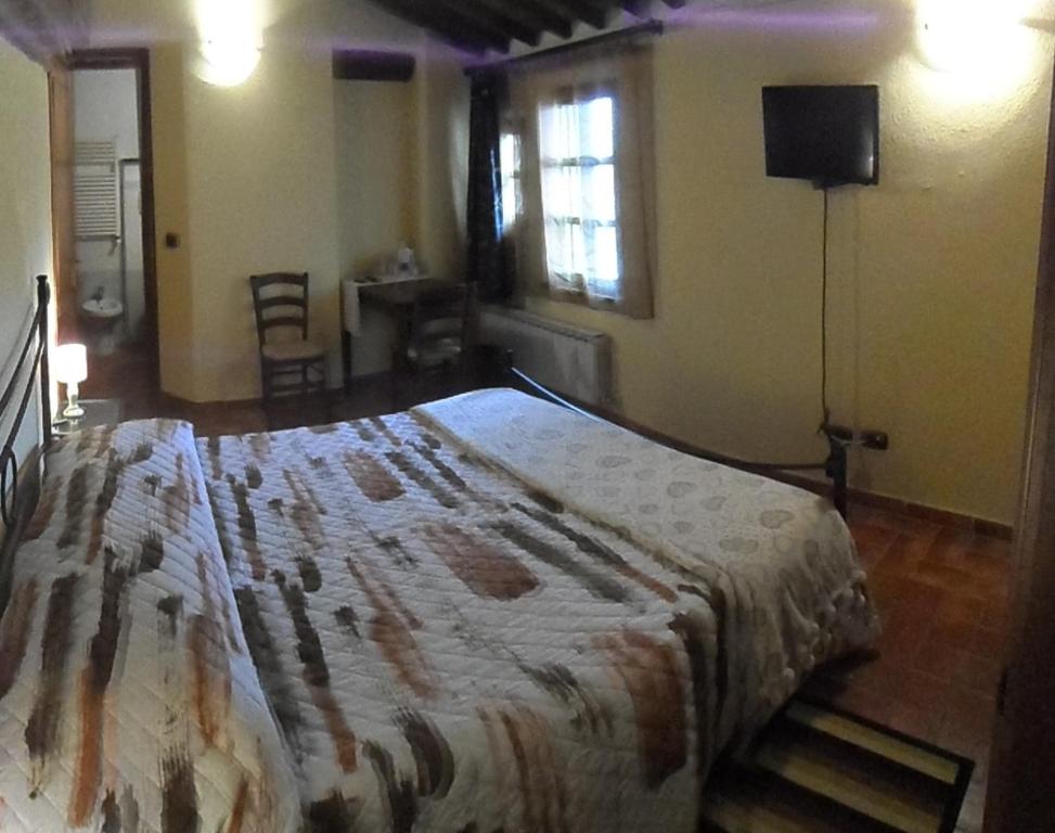 A bed or beds in a room at Il Pozzo Di Sant'Andrea