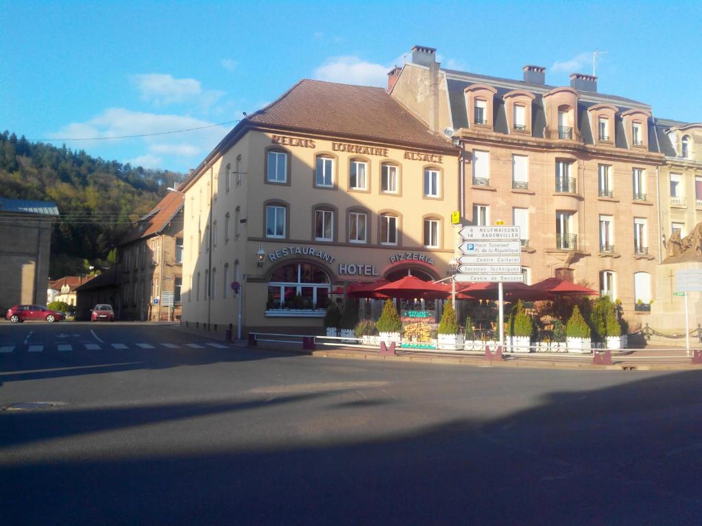 a large building on the side of a street at Relais Lorraine Alsace Pere & Fils in Raon-lʼÉtape