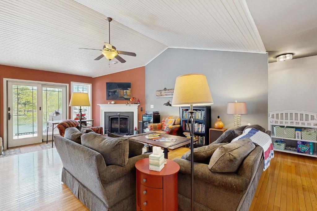 a living room with two couches and a fireplace at Herons Watch in Bumpass
