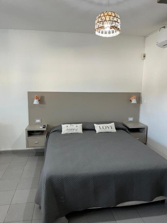 a bedroom with a black bed with two pillows on it at Dilans in San Luis