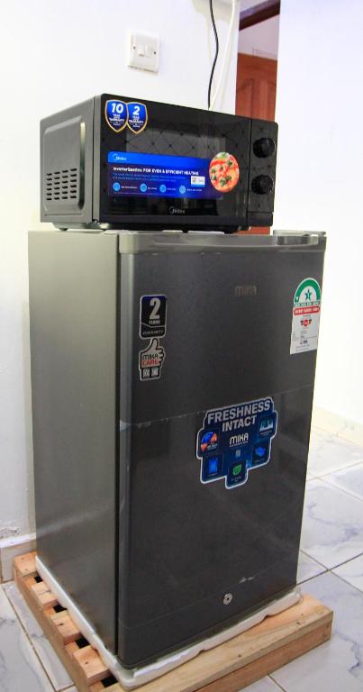 a refrigerator with a tv on top of it at D&A Homes in Eldoret