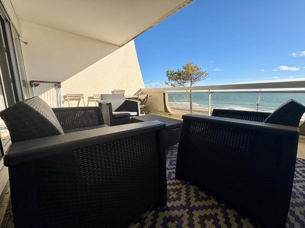 d'un balcon avec des chaises et une vue sur l'océan. dans l'établissement L'océan en toile de fond , appartement cosy, à La Baule