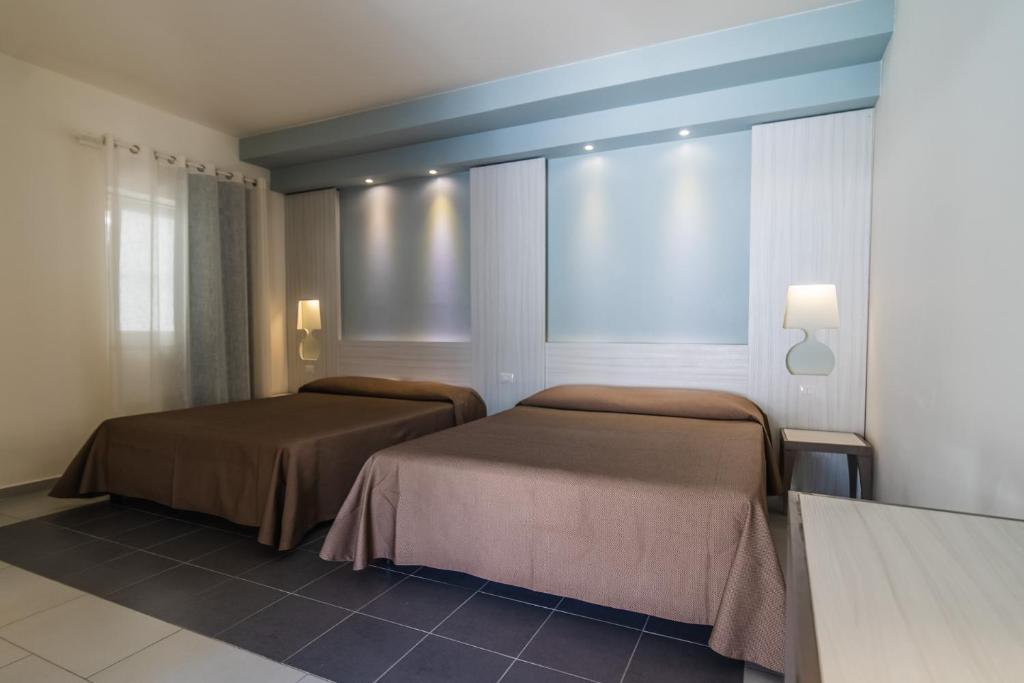 Postel nebo postele na pokoji v ubytování Hotel D'Amato