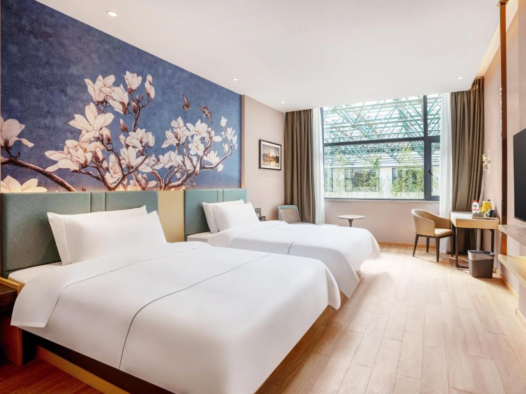 Postel nebo postele na pokoji v ubytování Guilin Magnotel Classic Hotel By Seven Star Park, Li River