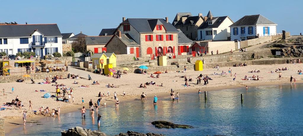 un groupe de personnes sur une plage près de l'eau dans l'établissement Maison Batz sur Mer Presqu'île de Guérande, à Batz-sur-Mer