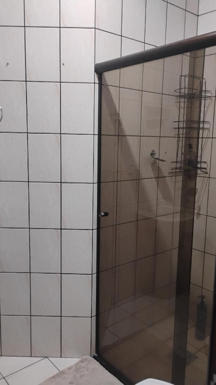 a shower with a glass door in a bathroom at Lar feliz in Sorriso