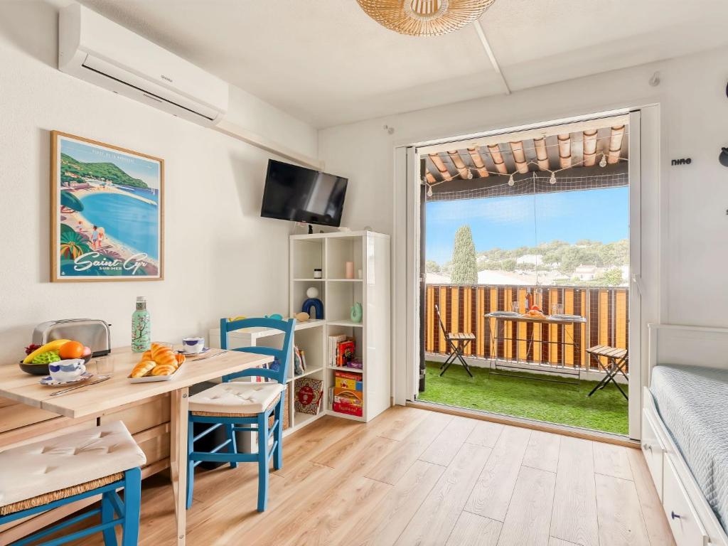 une cuisine avec une table et un bureau avec vue sur un balcon dans l'établissement Studio Les Aigues Marines-74 by Interhome, à Saint-Cyr-sur-Mer