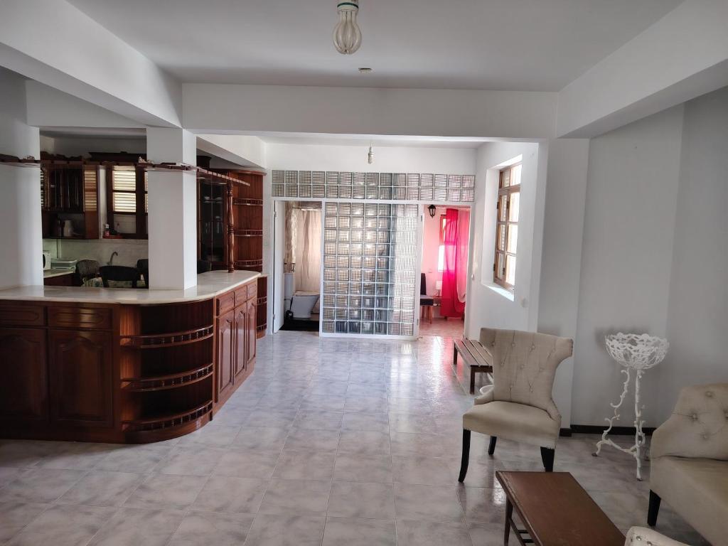 a room with a kitchen and a living room at Maya Mindelo Studio T1 in Mindelo