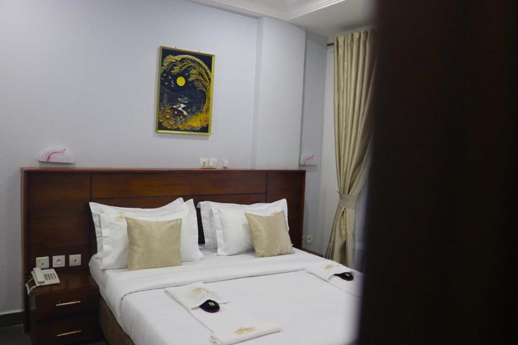 Postel nebo postele na pokoji v ubytování COFE Hôtel