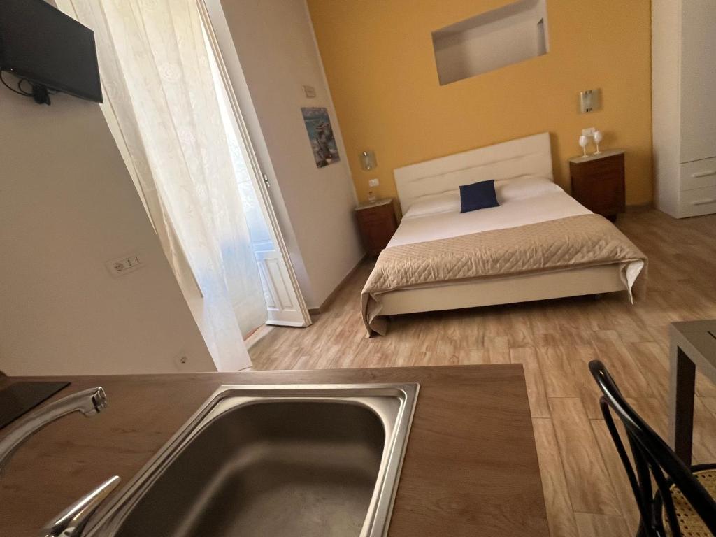 a bathroom with a bed with a sink and a tub at Il portale in Tropea